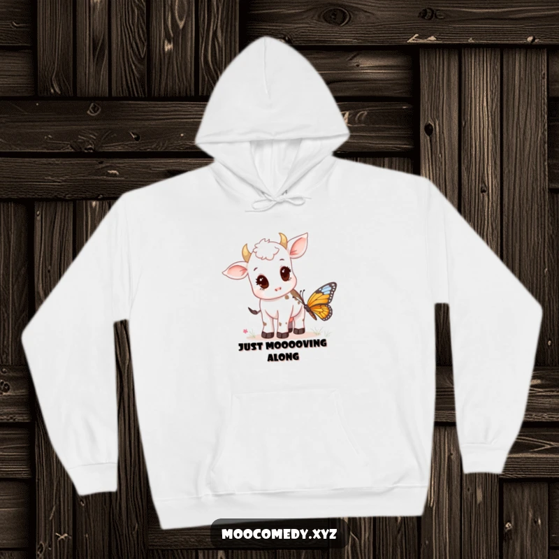 Funny hoodie showing a little cow calf intently observing a pretty butterfly in a grassy field.