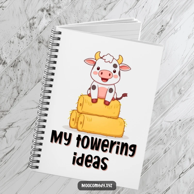 Funny notebook cover with a happy cow character precariously balancing a large stack of hay bales.