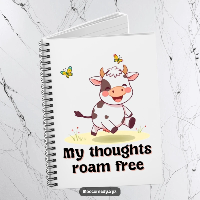 Funny notebook with a graphic of a happy cow chasing a butterfly, ideal for notes and creative ideas.