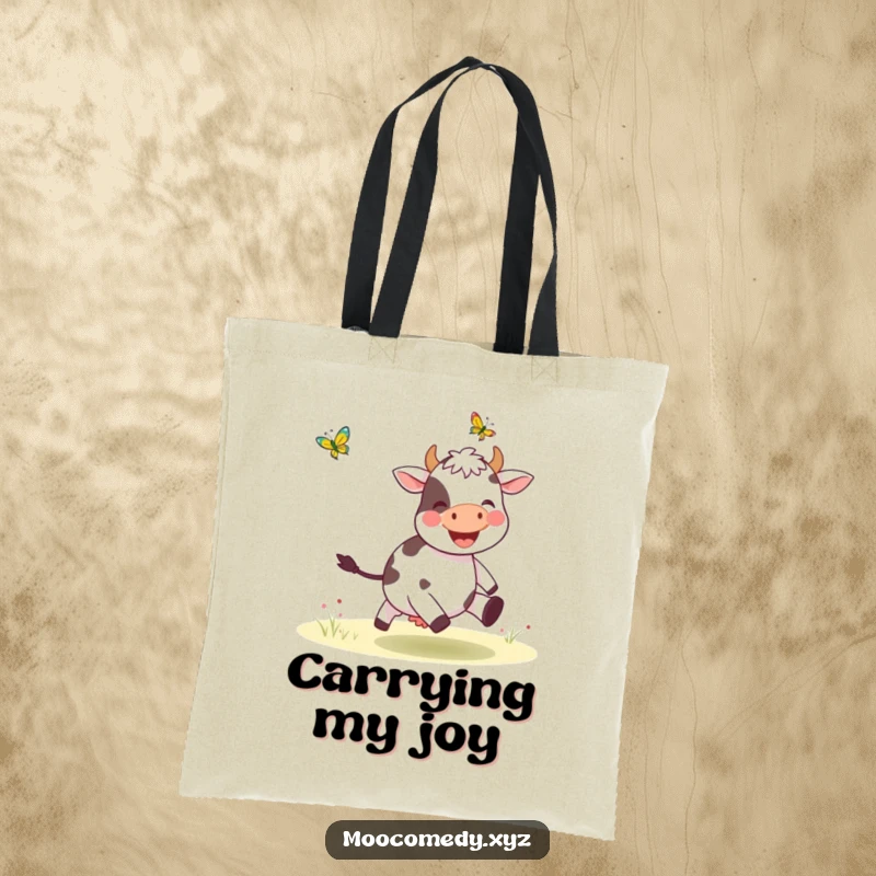 Funny tote bag featuring a joyful cow in pursuit of a fluttering butterfly, a charming and humorous accessory.